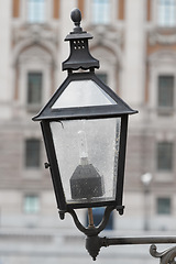 Image showing Outdoor, lamp and street in city, vintage and retro for urban Cape Town to illuminate objects or areas. Winter, antique and light post for security in dark or night, alert and bulb in garden or park