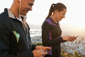 Image showing Earphones, phone and couple outdoor for fitness, music choice for workout and runner team with tech. Cardio, health and listening to radio with scroll on app, sports and motivation for exercise