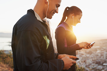 Image showing Earphones, cellphone and couple outdoor for fitness, music choice for workout and runner team with tech. Cardio, health and listening to radio with scroll on app, sports and motivation for exercise