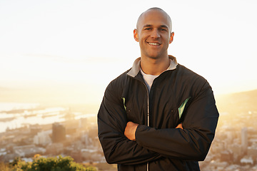 Image showing Happy man, portrait and fitness professional with sunset on mountain for workout, exercise or outdoor raining. Male person or athlete with smile and arms crossed in confidence for health and wellness