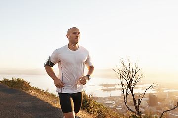 Image showing Athlete, man and running in road with music for sport, exercise and fitness for competition or marathon in nature. Runner, person and workout with wellness, seaside and earphones for cardio in Mexico