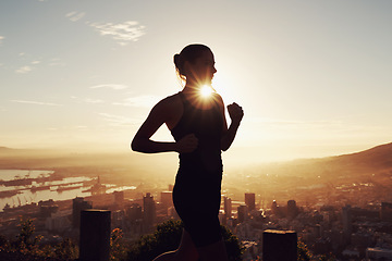 Image showing Fitness, running and woman in silhouette on mountain for health, wellness and strong body development. Workout, exercise and girl runner on sunset path in nature for training, performance and city