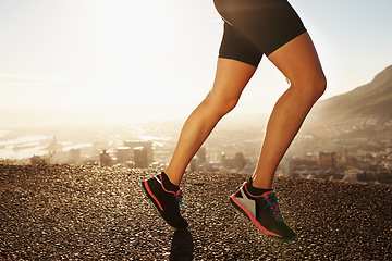 Image showing Legs, shoes and person running in city, cardio and fitness for health and wellness at sunrise. Athlete, marathon and speed with runner on road outdoor for exercise, workout and training in morning