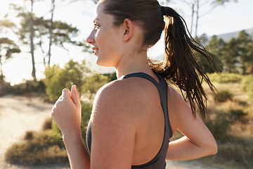 Image showing Fitness, running and woman on road in forest for health, wellness and strong body development. Workout, exercise and girl runner on path in nature for marathon training, performance and challenge.