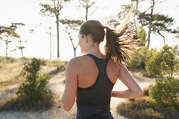 Image showing Fitness, running and woman on path in forest for health, wellness and strong body development. Workout, exercise and girl runner on road in nature for marathon training, performance and challenge.