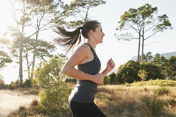 Image showing Exercise, running and woman on path in mountain for health, wellness and strong body development. Workout, fitness and girl runner on road in nature for marathon training, performance and challenge.