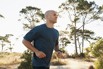 Image showing Fitness, running and man on path in forest for health, wellness and strong body development. Workout, exercise and runner on road in nature for marathon training, performance and morning challenge.