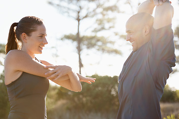 Image showing Fitness, trees and couple stretching arms for workout, commitment and healthy body in nature. Exercise, man and happy woman in warm up for training, muscle and morning in woods with personal trainer.