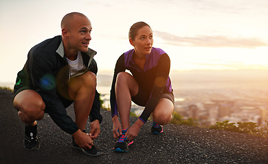 Image showing Fitness, shoes and couple in a road for sunset running, training or morning cardio in nature together. Sneakers, shoelace and sports runner people outdoor for marathon, routine or performance workout