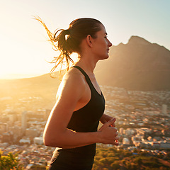 Image showing Fitness, running and woman with sunset in mountain for health, wellness and strong body development. Workout, exercise and girl runner in nature for marathon training, performance and city challenge.