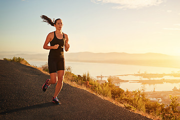 Image showing Fitness, running and woman on cliff at sunset for health, wellness and strong body development. Workout, exercise and girl runner on path in nature for marathon training, performance and challenge.