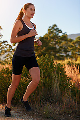 Image showing Runner, woman and marathon on trail with fitness for sport, training and exercise for competition in woods. Athlete, person and running with wellness, challenge and cardio for healthy body in Denmark