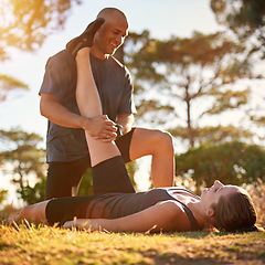 Image showing Forest, stretching and woman with man for fitness, workout coach and help for healthy body. Exercise, wellness and girl athlete with personal trainer in muscle warm up for outdoor training in morning