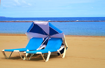 Image showing Two sun-beds on the beach