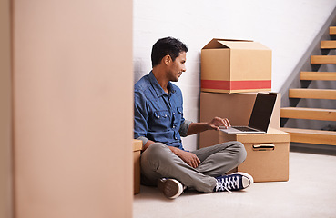 Image showing Man, laptop and boxes in new house, apartment and property for moving, relocating and buying a home. Male person, real estate and mortgage for homeowner with computer, communication or technology