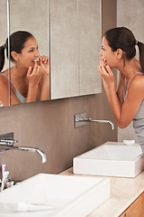 Image showing Mirror, bathroom and woman with floss for cleaning, oral hygiene and dental care in home. Morning routine, healthcare and person for whitening, wellness and grooming for gum disease and fresh breath