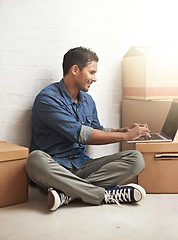 Image showing Man, boxes and laptop working in new home, house and residence for moving, relocating or buying property. Male person, real estate or mortgage for homeowner with computer, communication or technology