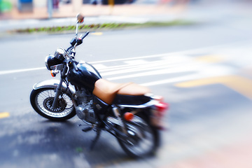 Image showing Blur, parked motorbike in street and transportation for travel in city, journey or road trip for speed and adventure. Motorcycle, ride and commute with stationary bike outdoor, power and moto machine