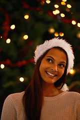 Image showing Happy woman, home and idea for gifts by christmas tree, love and giving in holiday season for care. Young person, smile and excited or inspiration for present and celebration with kindness in house