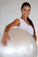 Image showing Happy woman, portrait and training with exercise ball for workout, health and wellness at home. Young female person or yogi with smile for pilates, warm up or fitness in confidence with gym equipment