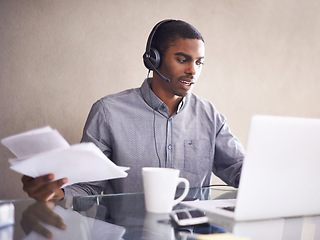 Image showing Businessman, laptop and headphones with paperwork for consulting, online advice or call center at office. Black man, consultant or African employee with documents and computer for customer service