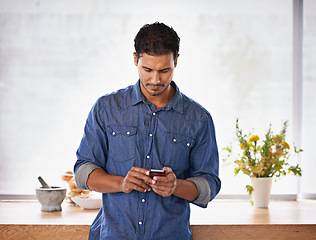 Image showing Man, phone and reading communication in kitchen with notification, typing and text message in home. Person, smartphone and internet for social media, mobile chat and online dating app in apartment