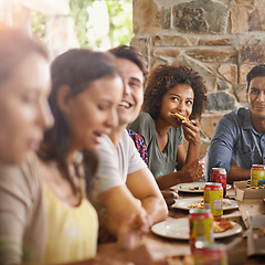 Image showing Friends, woman and eating of pizza in home with happiness, soda and social gathering for bonding in dining room. Men, group and fast food with smile, drinks and diversity at table in lounge of house