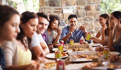 Image showing Friends, group and eating of pizza in home with happiness, soda and social gathering for bonding in dining room. Men, women and fast food with smile, drinks and diversity at table in lounge of house