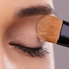 Image showing Closeup, lashes and brush for eyeshadow with woman, makeup and beauty with application on purple background. Cosmetology, transformation and cosmetic care with tools, powder product and shine