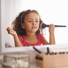 Image showing Child, girl and makeup with brush on mirror for role play for creativity and artistic. Kid, female person and bedroom with playing for development, growth and cute for childhood memories and fun.