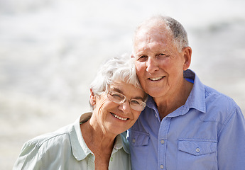 Image showing Elderly, couple and happy portrait at beach for retirement vacation or anniversary to relax with love, care and commitment with support. Senior man, woman and together by ocean for peace on holiday.