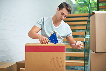 Image showing Man, packing and boxes in home for moving with investment in real estate, new house and tape for package safety. Person, face and cardboard by stairs for storage, cargo and relocating from property