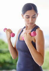 Image showing Woman, face and dumbbell with weightlifting for fitness in nature with strength, wellness and healthy body. Athlete, person and training equipment for exercise, workout or physical activity for arms