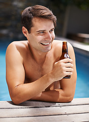 Image showing Man, relax and smile in swimming pool with beer to drink or chill on summer vacation, luxury and resort or villa. Male person, bottle and alcohol for refreshments on tropical holiday in Maldives.