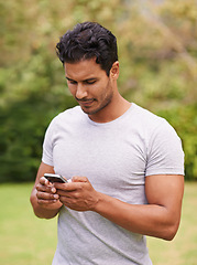 Image showing Man, outdoor and phone on grass, browse and watching social media or meme for entertainment in nature. Male person, backyard and tech to relax, scroll and vacation at home or house for peace