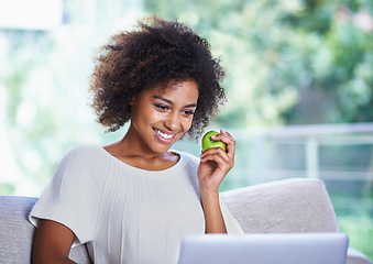 Image showing Laptop, smile and happy woman with apple, sofa and home lounge for relax and online. Technology, computer and scrolling on social media website, app or internet for connection with healthy snack