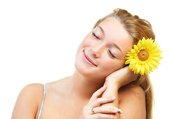 Image showing Skincare, smile and happy woman in studio with sunflower in her hair for natural cosmetics on white background, Flower, face or female model with wellness, glowing skin or organic beauty treatment