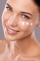 Image showing Portrait, cream and woman with skincare, cosmetics and dermatology on grey studio background. Face, person and model with lotion and shine with wellness and beauty with moisturise, smile or aesthetic