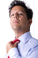 Image showing businessman adjusting his necktie 