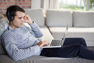 Image showing Relax, headphones or man on laptop for streaming movies, music or film series in home to research. Podcast, radio or person on sofa listening online on technology for digital blog or playlist on web
