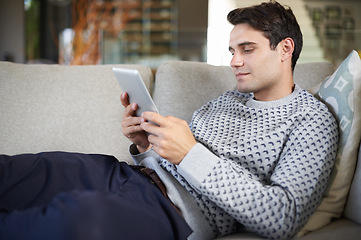 Image showing Relax, research or businessman on tablet for social media blog, post or networking on sofa. Streaming movie, couch or person typing online for planning or technology for update, email or news in home