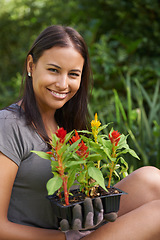 Image showing Happy woman, portrait with flowers and garden in backyard, nature and sustainability for environment. Landscaping, gardener with plant in soil or fertilizer for growth, eco and botanical outdoor