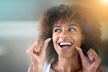 Image showing African woman, dental floss and happy for cleaning for oral wellness, health or benefits for mouth in bathroom. Girl, person and teeth whitening with string, lens flare or change for results in house