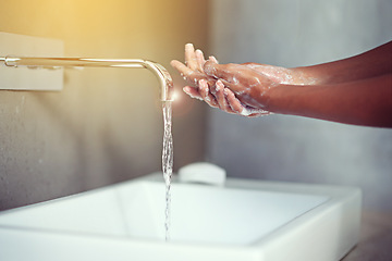 Image showing Hands, water and soap for cleaning with person in bathroom, hygiene and wellness for protection from germs. Bacteria, virus and disinfection at sink with foam, skincare and cosmetics in routine