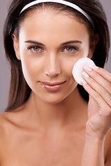 Image showing Beauty, woman in portrait and cotton pad for cleaning makeup, hand for hygiene and skincare with wellness. Wipe, cosmetic product and dermatology for healthy skin and facial with glow in studio