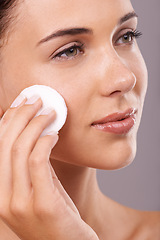 Image showing Beauty, cotton pad and and woman for skincare, routine cleaning with hygiene and makeup removal isolated on grey background. Wipe, cosmetic product and dermatology for healthy skin and glow in studio