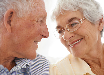 Image showing Couple, senior and happy or love in looking, home and relax together for bonding and smile. Elderly people, romance and care in marriage or relationship in retirement, closeup and security in house