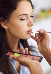 Image showing Woman, makeup artist and hand for lipstick application or beauty treatment with cosmetic products, preparation or mouth. Female person, finger and brush for makeover glamour, skincare or professional