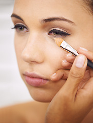 Image showing Woman, makeup and cosmetics with brush for facial treatment, beauty or eye shadow at home. Closeup of female person, face or model applying foundation, contour or glow for skincare, color or glamour