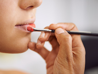 Image showing Closeup, woman and makeup brush on lips for beauty with hands, application of cosmetics product and glamour. Person, mouth and color lipstick for skincare, aesthetic makeover and cosmetology at salon